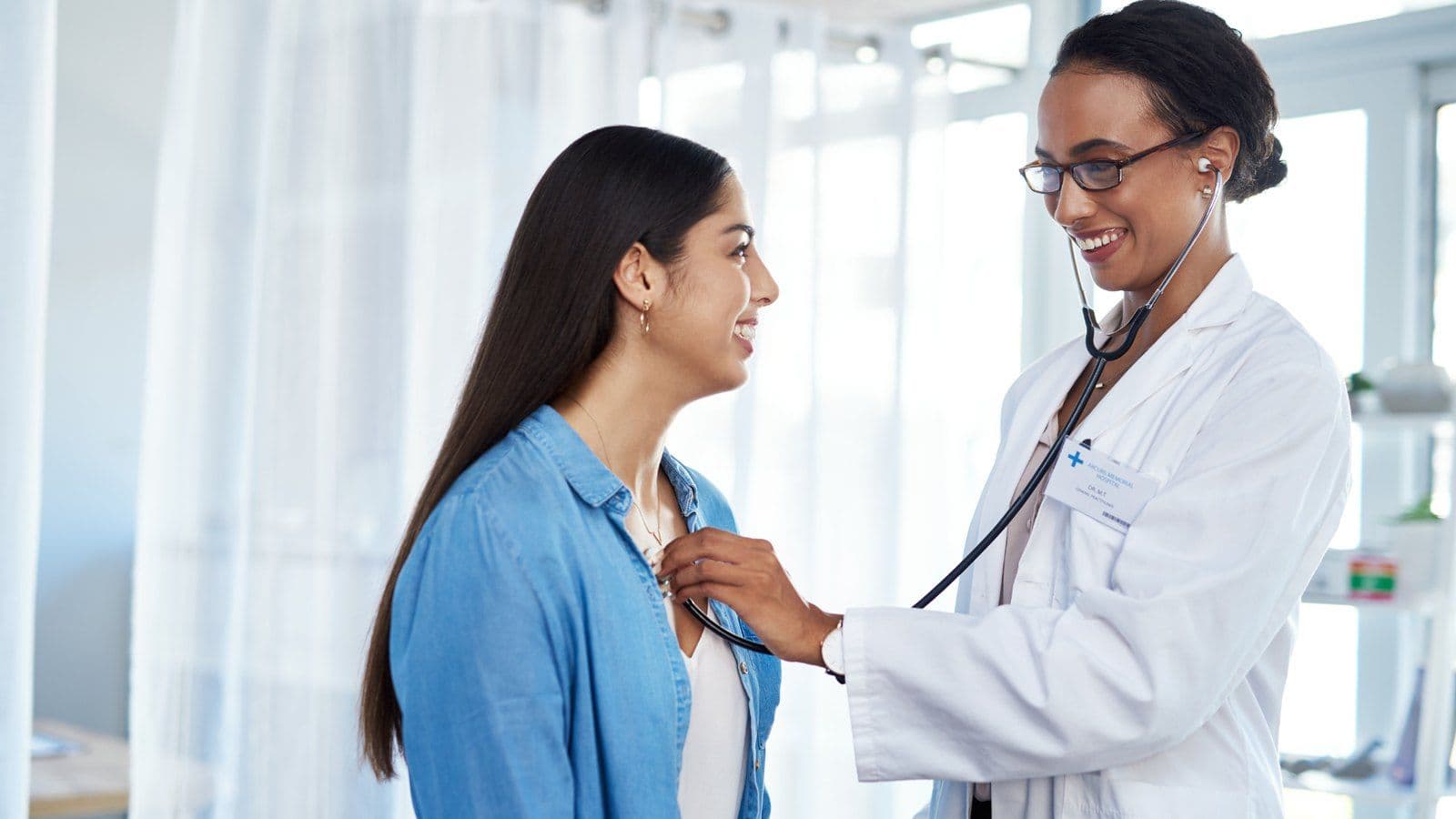 Medecin auscultant le coeur d'une patiente au stethoscope